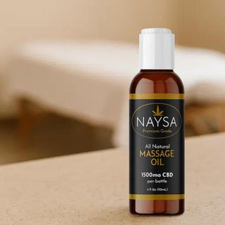 Bottle of NAYSA all natural massage oil on a beige background