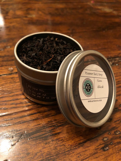 KC Tea Company's Pioneer Grey - Organic Earl Grey Tea on wood background